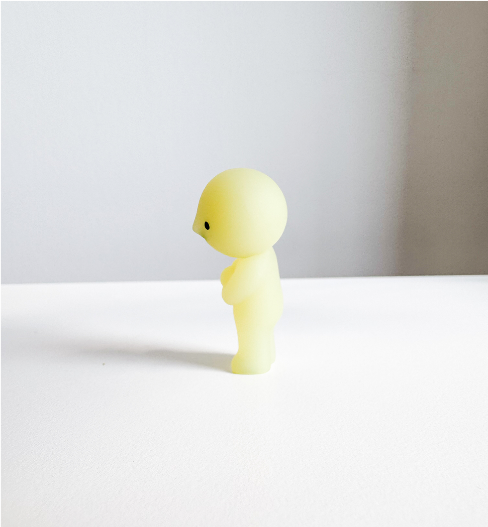 Image of Smiski figurine from the side view.