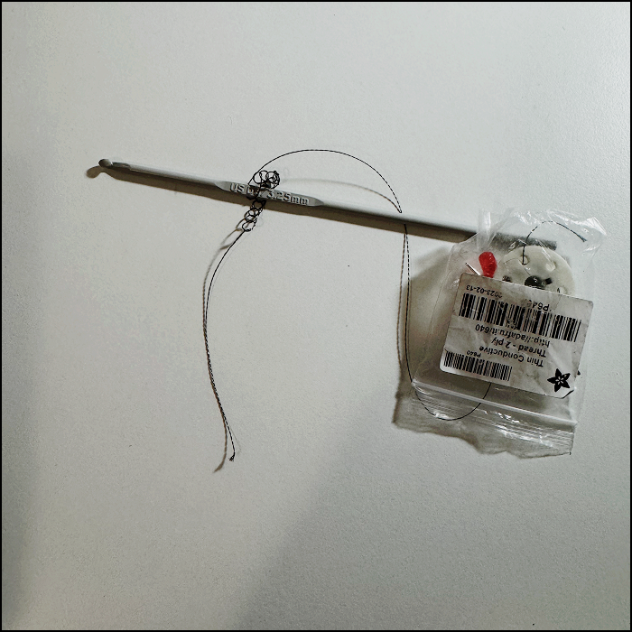 Attempting to crochet with the conductive thread to explore possible pathway for wearable circuit option. Consisting of stich called (chains)