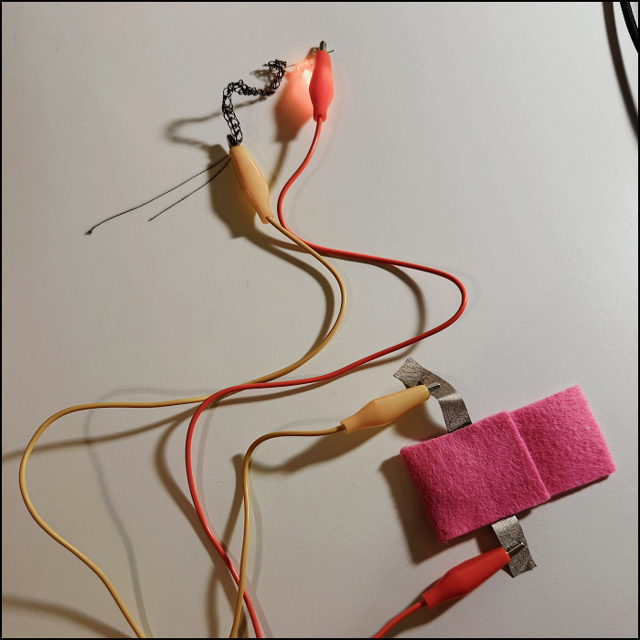 Circuit inside the fabric taken out and shown, utilizing the conductive thread which was turned into an easier material to work with by crocheting the thread.